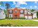 Beautiful two-story brick home with manicured lawn and two-car garage at 5147 Winding Glen Dr, Lithonia, GA 30038