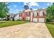 Inviting two-story home featuring a spacious driveway and attached two-car garage at 5147 Winding Glen Dr, Lithonia, GA 30038