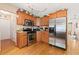 Modern kitchen featuring stainless steel appliances, wooden cabinets, and hardwood floors at 5147 Winding Glen Dr, Lithonia, GA 30038