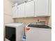Bright laundry room with white washer and dryer and ample storage at 5147 Winding Glen Dr, Lithonia, GA 30038
