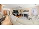 Bright living room featuring hardwood floors, white sofa, fireplace, and a large screen TV at 5147 Winding Glen Dr, Lithonia, GA 30038