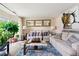 Inviting living room with neutral tones, plush sofas, decorative mirrors and ample natural light at 5147 Winding Glen Dr, Lithonia, GA 30038