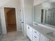 Elegant bathroom featuring a double vanity with granite countertops and modern fixtures at 157 Longhorn Way, Auburn, GA 30102