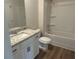 Bathroom featuring a tub and shower combination, granite countertops and vinyl floors at 157 Longhorn Way, Auburn, GA 30102