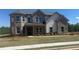 Charming two-story brick home with manicured lawn and landscaping at 157 Longhorn Way, Auburn, GA 30102