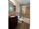 Bathroom features tiled walls, vanity and tub with glass sliding doors at 1604 Steele Nw Dr, Atlanta, GA 30309