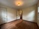 Bedroom with dark hardwood floors and an adjacent doorway at 1604 Steele Nw Dr, Atlanta, GA 30309