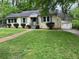 Single story home with a well-kept front lawn, charming facade and driveway leading to attached garage at 1604 Steele Nw Dr, Atlanta, GA 30309