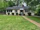 Charming single story home featuring a well-maintained lawn and traditional architecture in a tree-lined neighborhood at 1604 Steele Nw Dr, Atlanta, GA 30309
