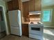 Efficient kitchen with white appliances, tile backsplash, and ample cabinet space at 1604 Steele Nw Dr, Atlanta, GA 30309