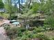 Serene pond with landscaped deck and view of the neighborhood homes at 1604 Steele Nw Dr, Atlanta, GA 30309