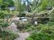 Picturesque pond view, with landscaped terrace and surrounding greenery at 1604 Steele Nw Dr, Atlanta, GA 30309