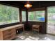 Bright sunroom with classic paneling, windows and vintage furnishings at 1604 Steele Nw Dr, Atlanta, GA 30309