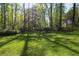 Spacious backyard features a lush green lawn surrounded by mature trees and landscaping at 4554 Meadow Valley Dr, Atlanta, GA 30342