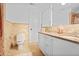 Bathroom featuring tile walls, granite countertop, double sinks, and vanity mirror at 4554 Meadow Valley Dr, Atlanta, GA 30342