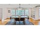 Open dining room with a rustic table, natural light, and decorative shelving at 4554 Meadow Valley Dr, Atlanta, GA 30342