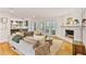 Bright and airy living room boasts a cozy fireplace, hardwood floors, and backyard access at 4554 Meadow Valley Dr, Atlanta, GA 30342