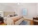 Bedroom with a tufted headboard, accent pillows, and a colorful throw blanket at 4554 Meadow Valley Dr, Atlanta, GA 30342