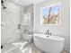 Elegant bathroom featuring a glass enclosed shower and a soaking tub at 490 Hammons Way, Atlanta, GA 30315