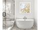 Modern bathroom features a freestanding tub and a marble-tiled shower with glass door at 490 Hammons Way, Atlanta, GA 30315