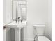 Stylish half-bath features a white pedestal sink and modern black fixtures at 490 Hammons Way, Atlanta, GA 30315