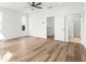Large bedroom with hardwood floors, a ceiling fan, and ensuite bathroom at 490 Hammons Way, Atlanta, GA 30315
