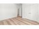 Bedroom featuring wood floors, neutral walls, and double doors for closet space at 490 Hammons Way, Atlanta, GA 30315