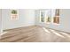 Bright bedroom with wood-look floors, three large windows, and white walls for a modern and spacious feel at 490 Hammons Way, Atlanta, GA 30315