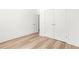 Bedroom featuring wood floors, neutral walls, and double doors for closet space at 490 Hammons Way, Atlanta, GA 30315