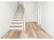 Bright entryway with wood flooring and a staircase leading to the upper level. Perfect for a grand entrance at 490 Hammons Way, Atlanta, GA 30315