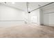 Spacious garage with concrete floor, access door to house, and overhead door at 490 Hammons Way, Atlanta, GA 30315