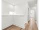 Bright hallway showcasing hardwood floors and neutral paint, connecting various rooms at 490 Hammons Way, Atlanta, GA 30315