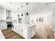 An open-concept living space showcasing a modern kitchen flowing into a bright living room with a fireplace at 490 Hammons Way, Atlanta, GA 30315