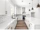 Sleek modern kitchen with white cabinets, quartz countertops, and stainless steel appliances and lighting at 490 Hammons Way, Atlanta, GA 30315