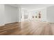 Open living room featuring a tiled fireplace with a wood mantel, wood-look flooring, and an abundance of natural light at 490 Hammons Way, Atlanta, GA 30315