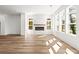 Bright living room features a modern fireplace, wood floors, and large windows that provide natural light at 490 Hammons Way, Atlanta, GA 30315