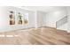 Sunlit living room with hardwood floors, large windows, and staircase at 490 Hammons Way, Atlanta, GA 30315