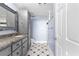 Stylish bathroom featuring dual vanity with granite counters, and custom tile work at 1500 Tara Pl # 810, Hampton, GA 30228