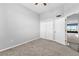 Bedroom featuring plush carpet, ceiling fan, closet and a view into living area at 1500 Tara Pl # 810, Hampton, GA 30228