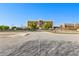 View of the building exterior with mature trees and parking area on a bright day at 1500 Tara Pl # 810, Hampton, GA 30228