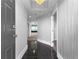 Condo foyer with dark floors, bright lighting and a view into the main room at 1500 Tara Pl # 810, Hampton, GA 30228