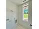 Convenient laundry room with tile flooring, natural light, and essential hook-ups at 31 Cedar Gate Ln, Kingston, GA 30145