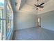 Bright main bedroom featuring tray ceilings, ceiling fan, and large windows at 31 Cedar Gate Ln, Kingston, GA 30145