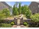 Beautiful backyard area with stone wall and gate leading to a grassy area and lots of trees at 705 Abbington River Ln, Atlanta, GA 30339