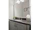 Elegant half bathroom features a sleek vanity with modern fixtures and updated lighting at 705 Abbington River Ln, Atlanta, GA 30339