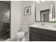 Modern bathroom featuring a glass-enclosed shower and sleek vanity with ample storage at 705 Abbington River Ln, Atlanta, GA 30339