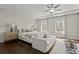 Bright and spacious bedroom with hardwood floors, ceiling fan and a sitting area at 705 Abbington River Ln, Atlanta, GA 30339