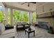 Relaxing covered porch with fireplace, comfortable seating, and wooded views at 705 Abbington River Ln, Atlanta, GA 30339