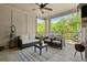 Inviting covered porch with stone fireplace, plenty of seating, and wooded views at 705 Abbington River Ln, Atlanta, GA 30339