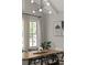 Dining room features stylish chandelier, natural light, modern art and cathedral ceiling at 705 Abbington River Ln, Atlanta, GA 30339